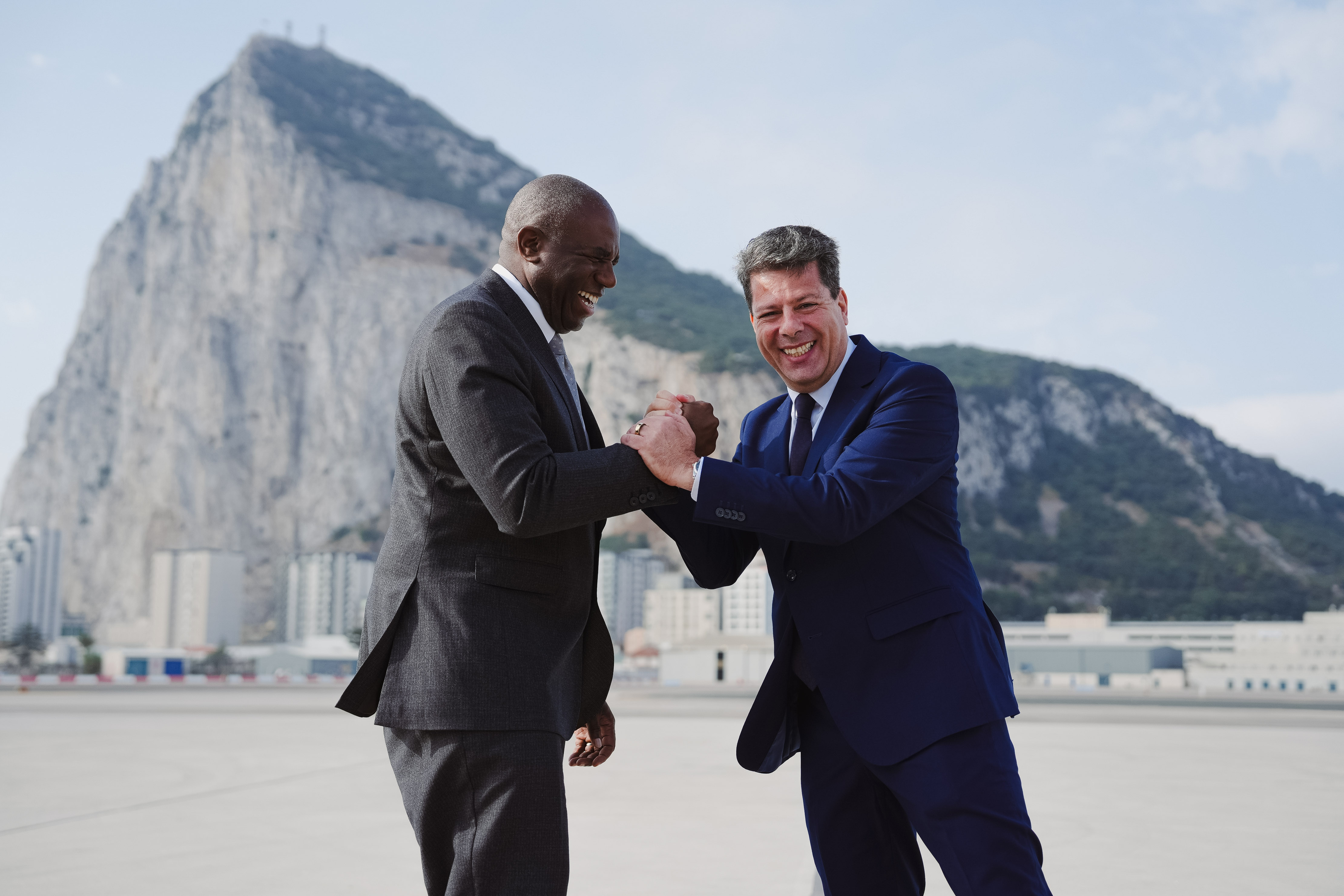 Foreign Secretary David Lammy and Chief Minister Fabian Picardo shake hands with Gibraltar's Rock in the background.