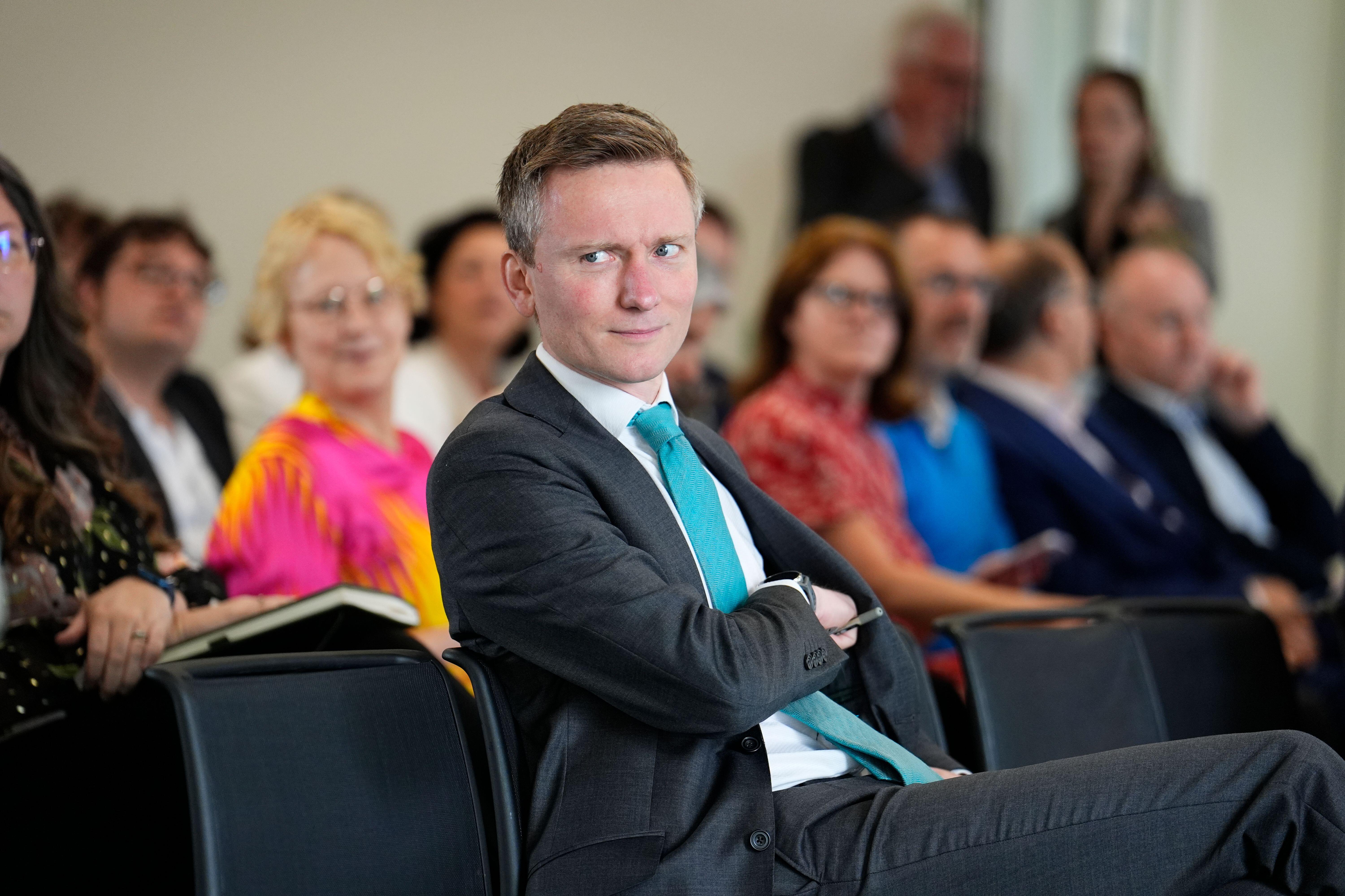Pensions minister Torsten Bell looking over his shoulder while seated among an audience.