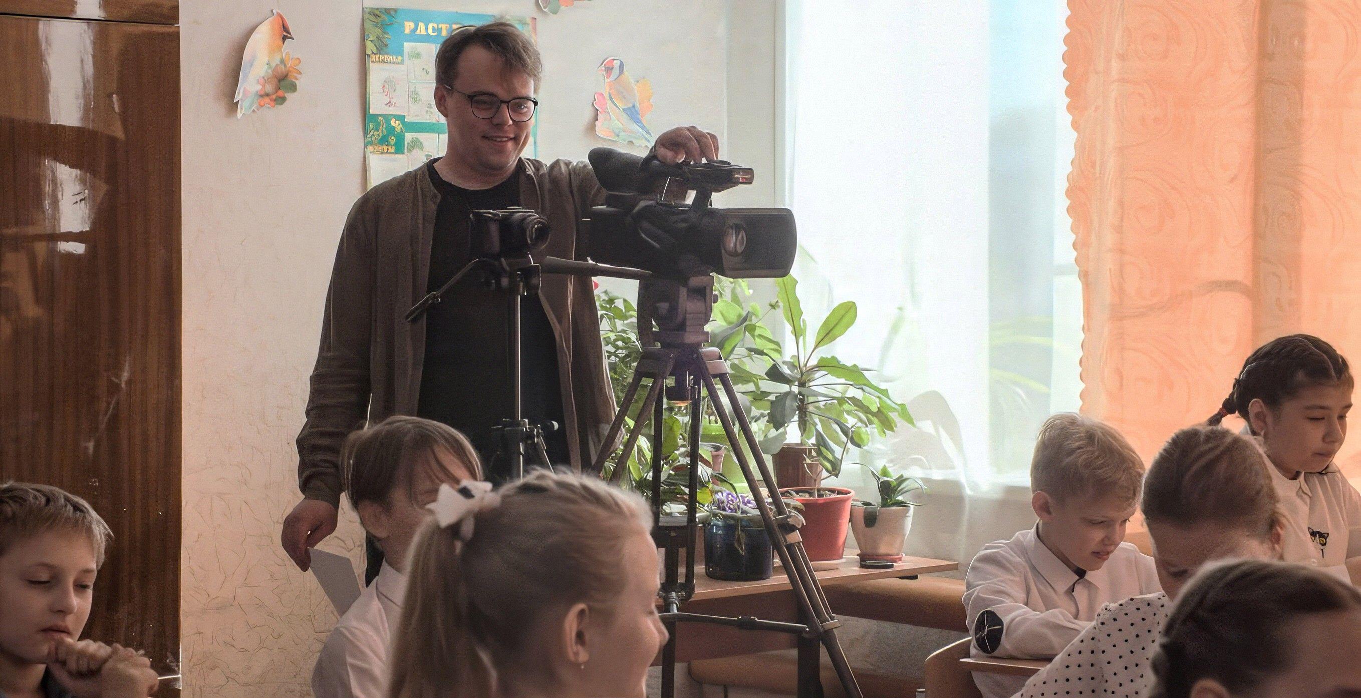 Pavel Talankin filming a documentary in a classroom.