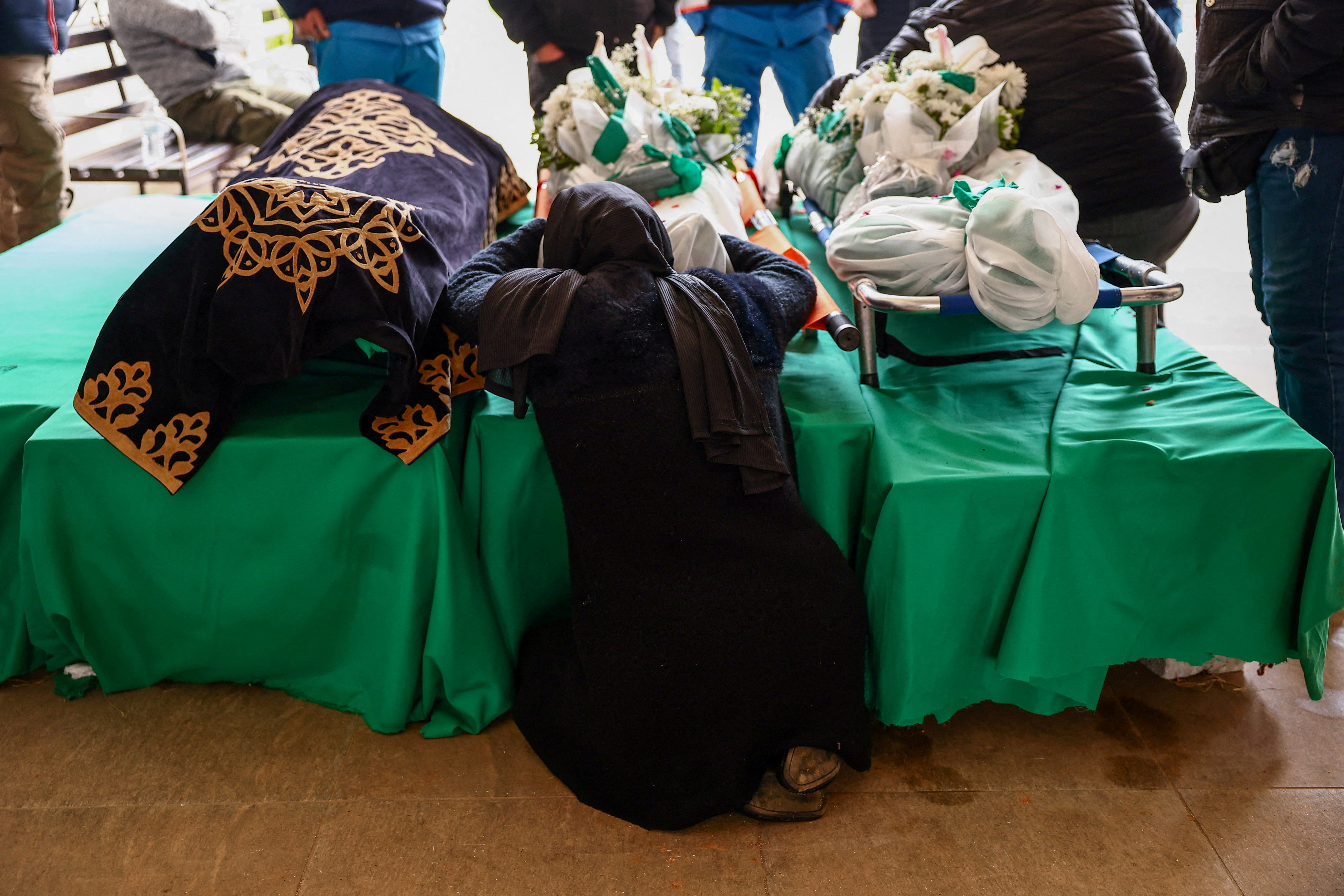 The mother of one of two paramedics killed by an Israeli strike mourns in Nabatieh, Lebanon