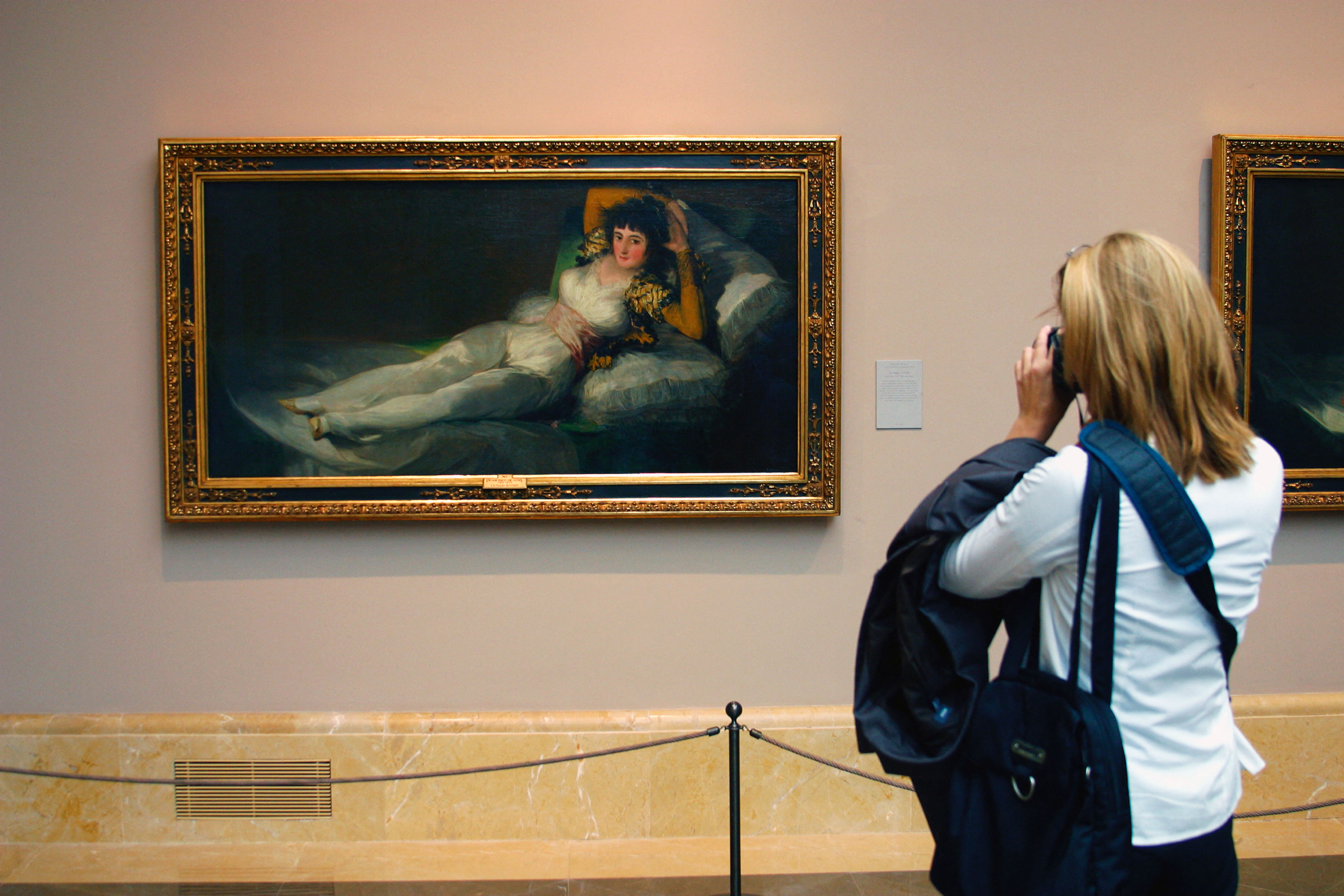 A visitor photographing Francisco de Goya's The Clothed Maja at the El Prado Museum in Madrid, Spain.