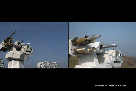 Animated GIF showing two views of a missile being fired from a military weapon system.