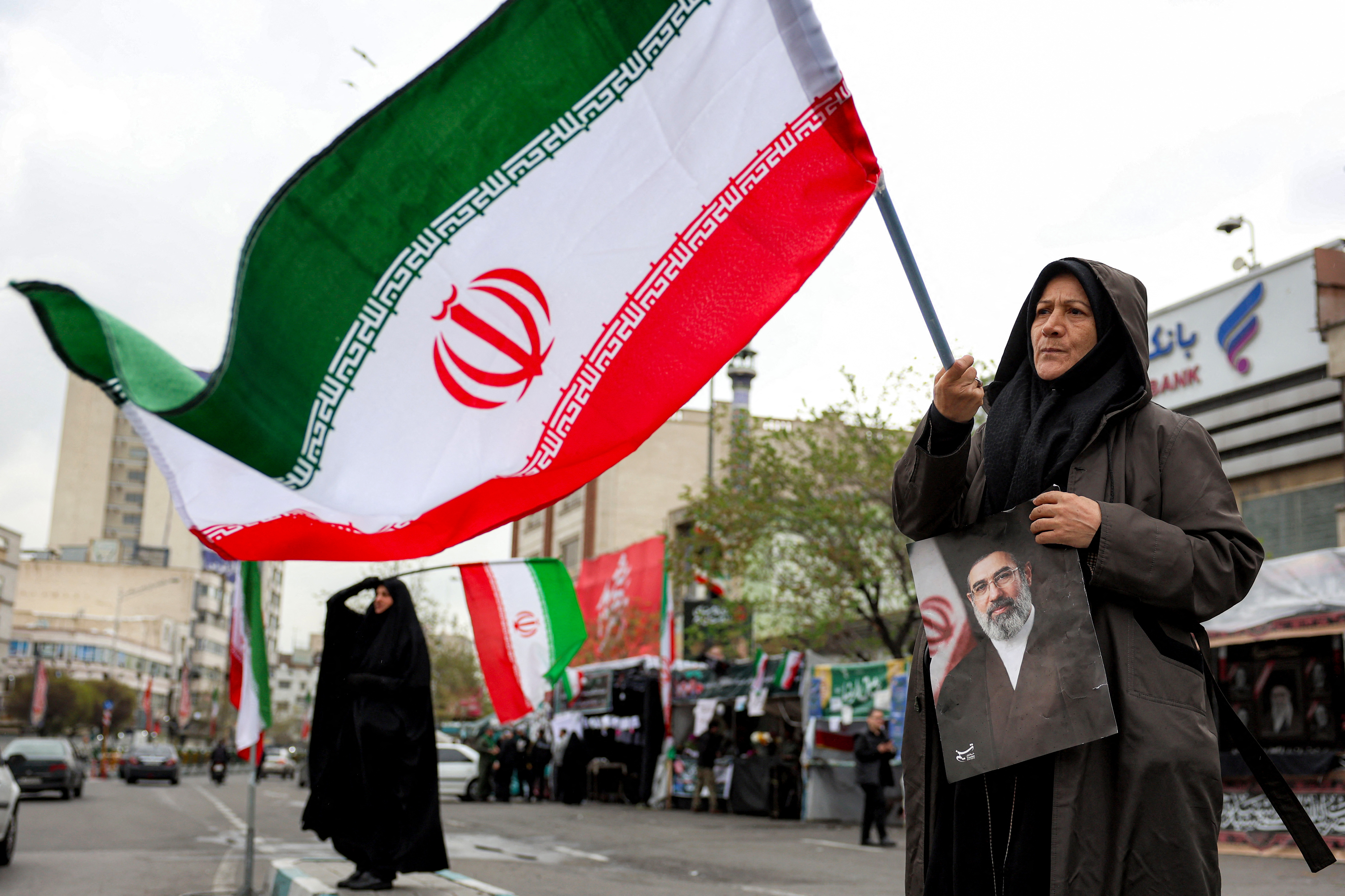 A woman holds a picture of Iran’s supreme leader, Mojtaba Khamenei, in Tehran