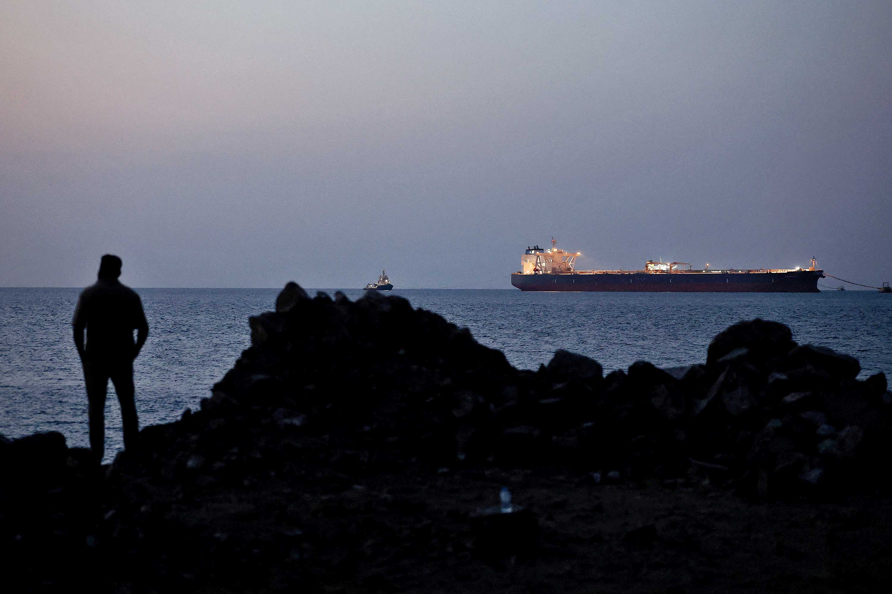 The Parnassos, a crude oil tanker, sits anchored off Muscat while passage through the Strait of Hormuz is halted