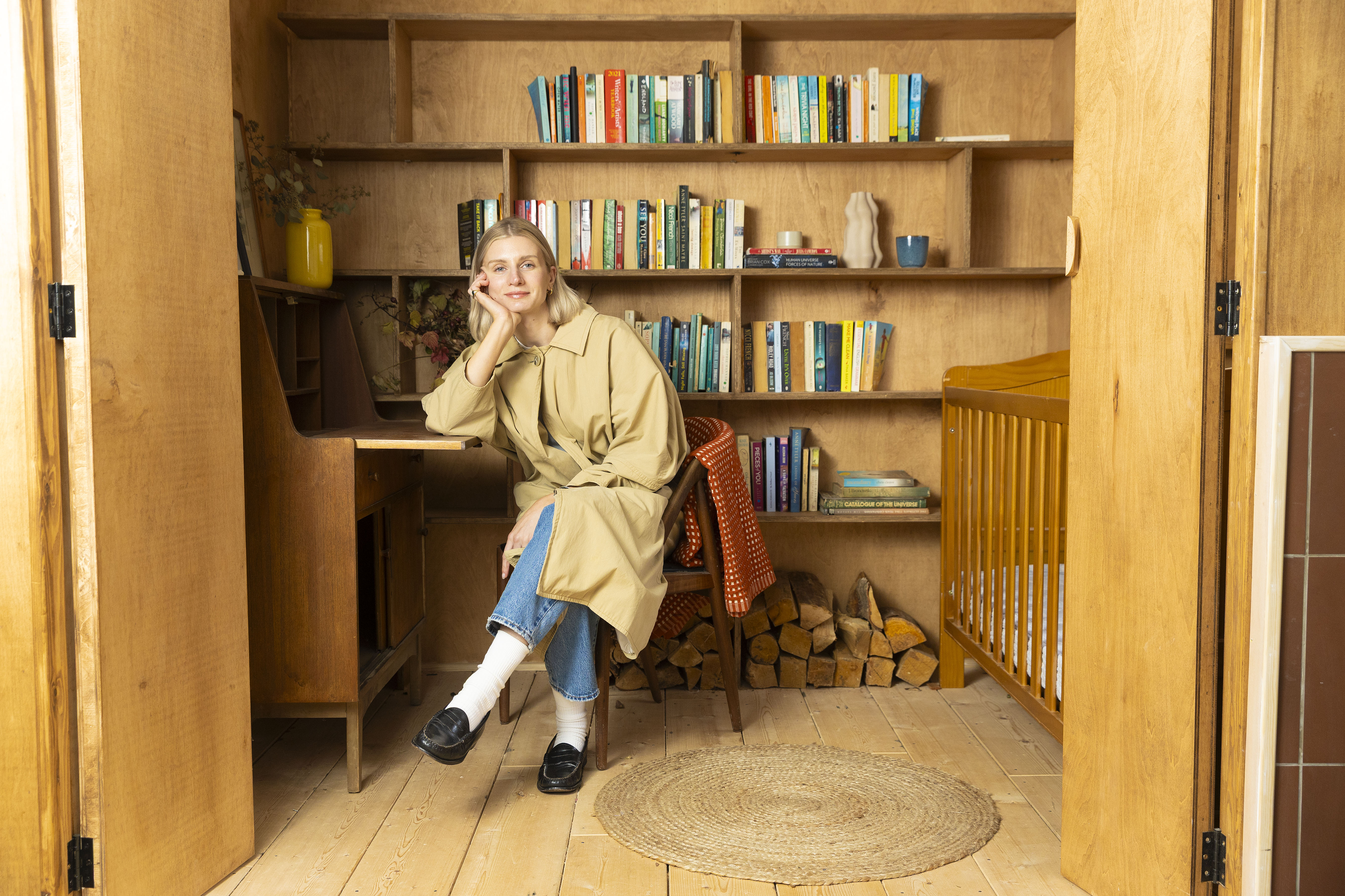 Rosanna Irwin poses for photographs with her houseboat in west London.
