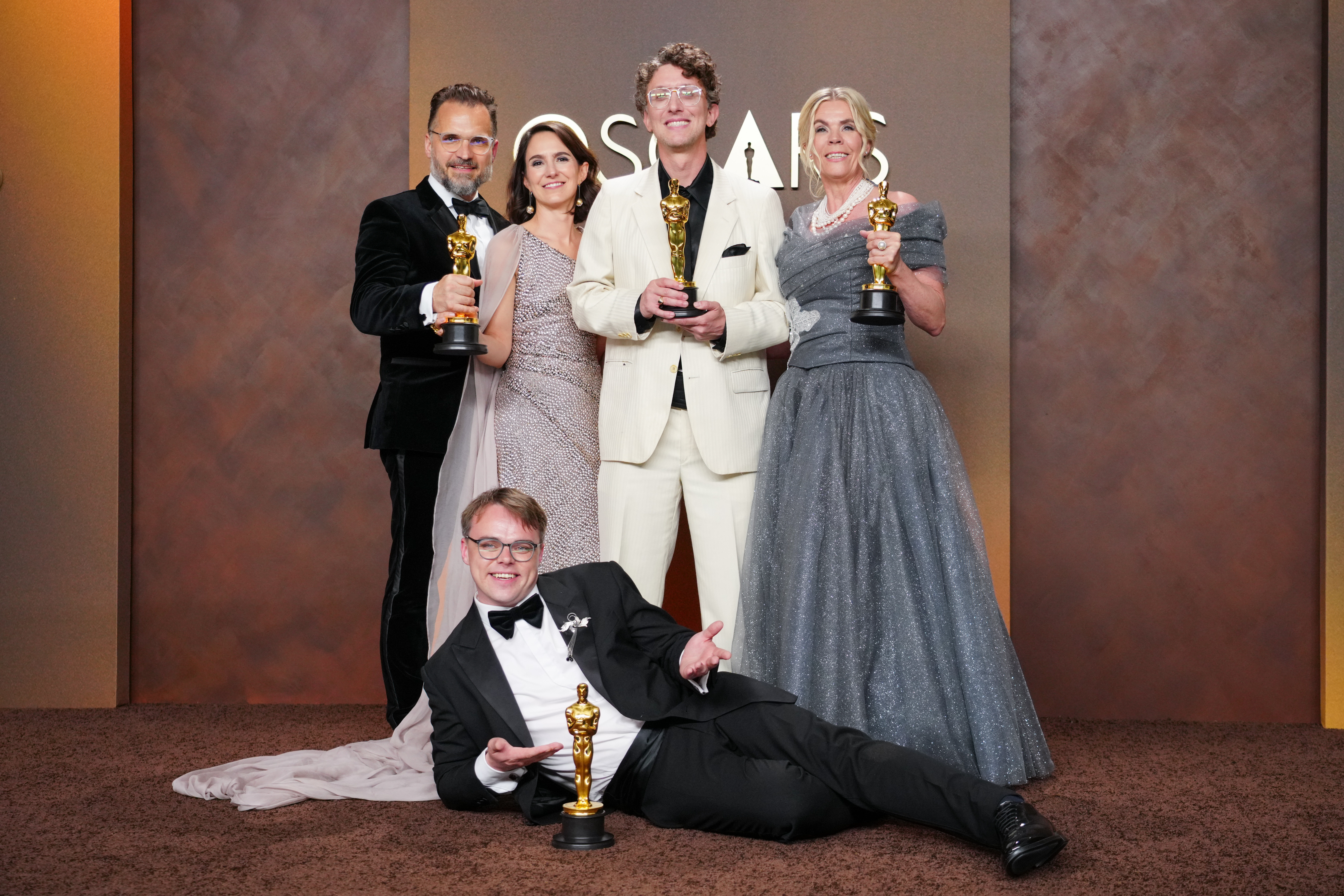 Pavel Talankin, Radovan Sibrt, Alzbeta Karaskova, David Borenstein, and Helle Faber posing with their Oscar awards.