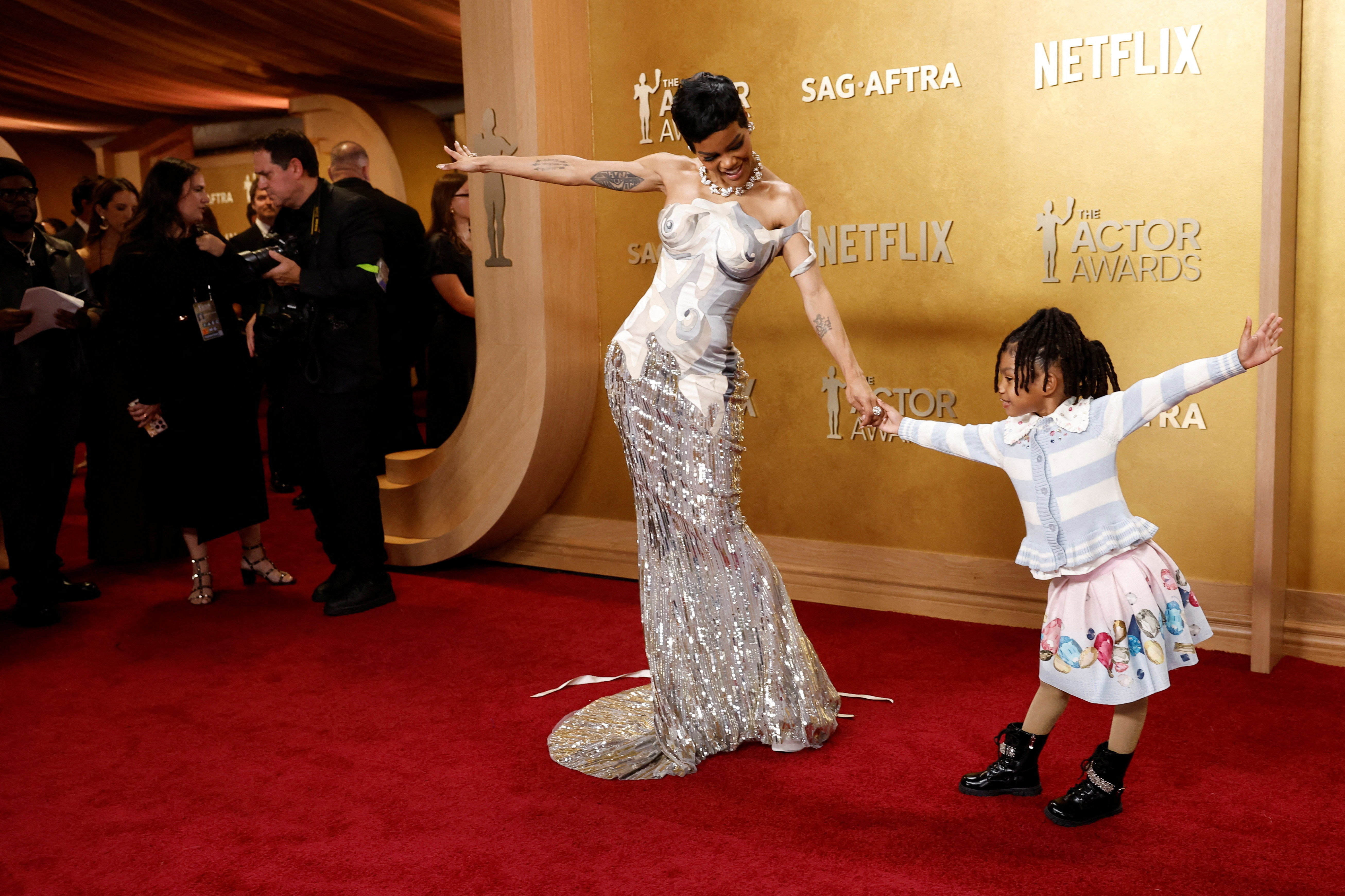 Teyana Taylor and Rue Rose Shumpert pose on the red carpet during the Actor Awards.