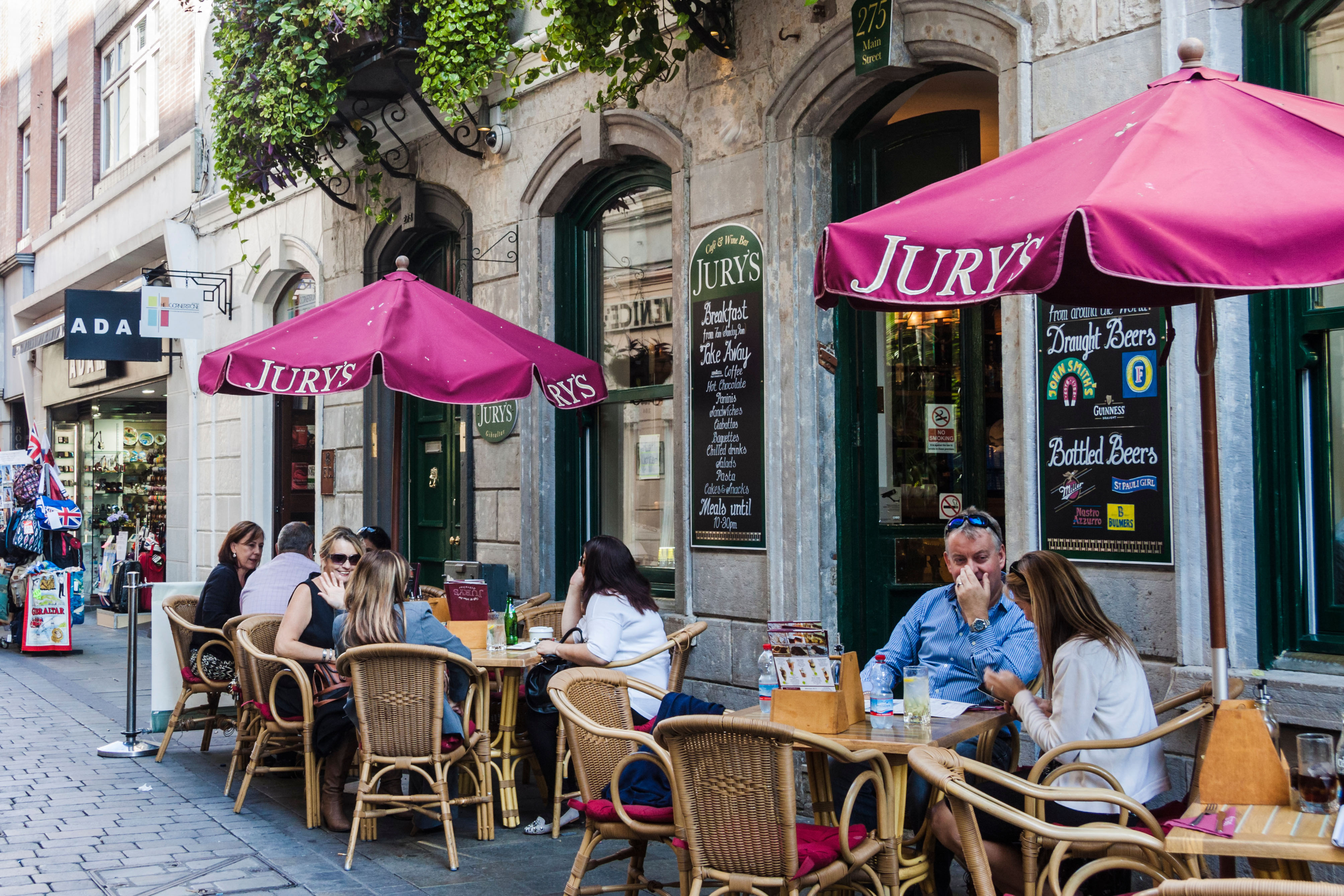 People sitting outdoors at Jury's pub in Main Street, Gibraltar.