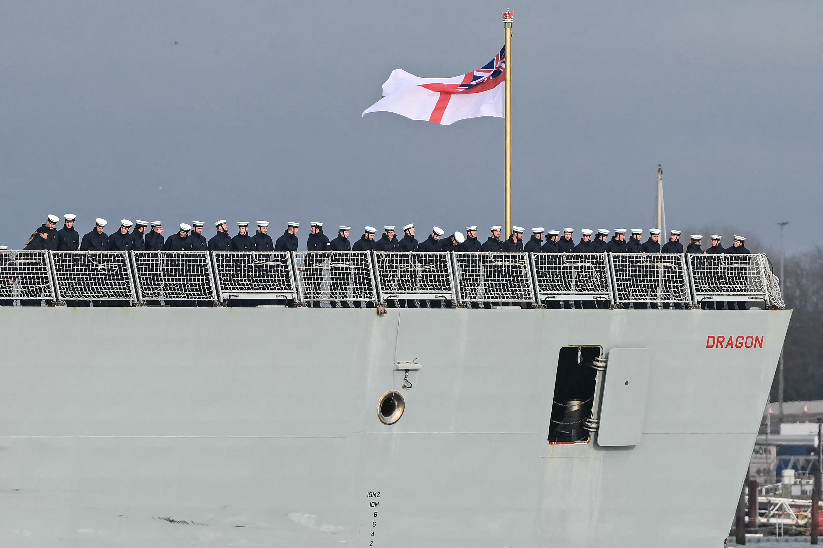 HMS Dragon’s crew line the deck