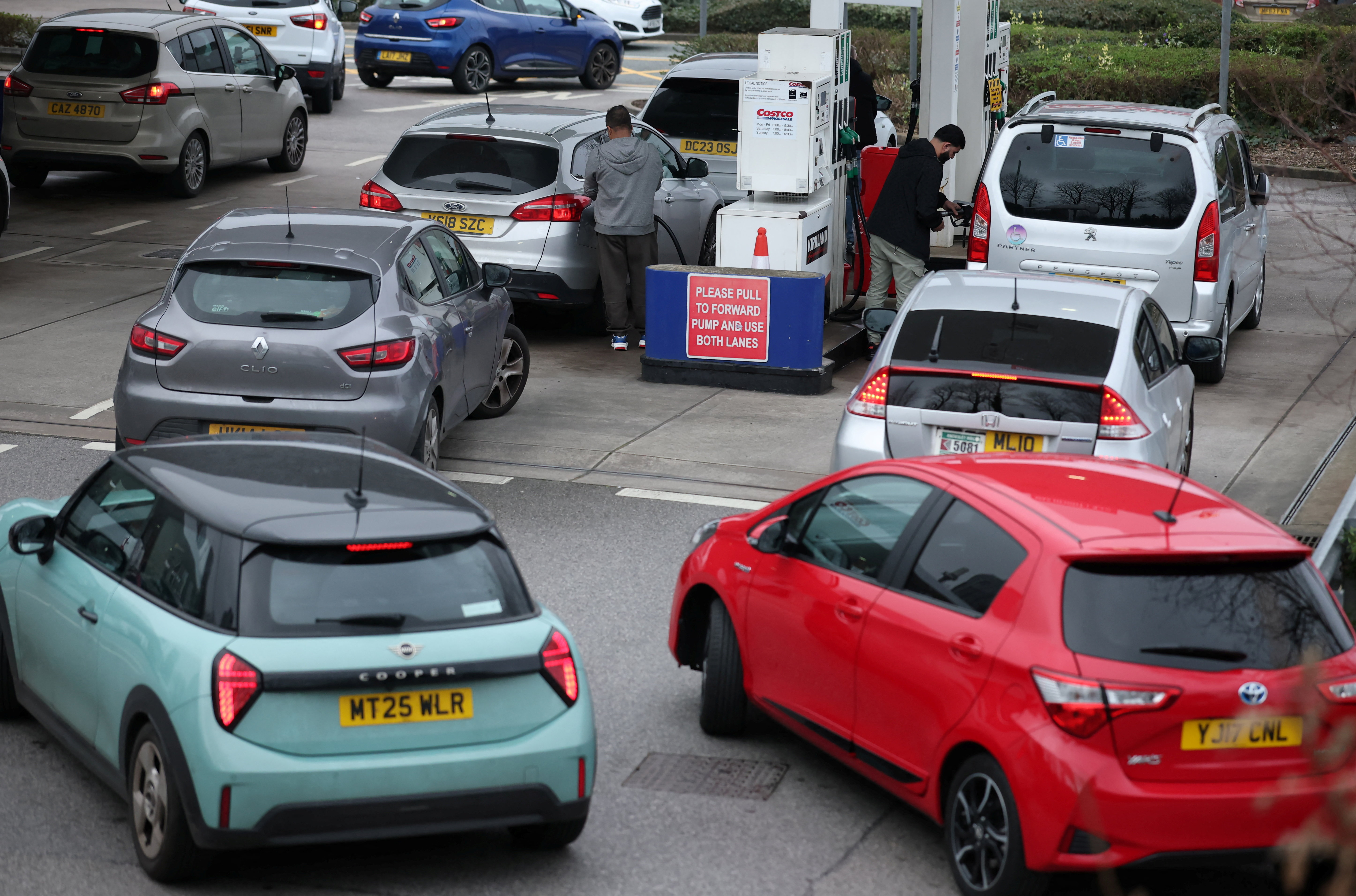 Motorists queue for fuel at a Costco filling station.