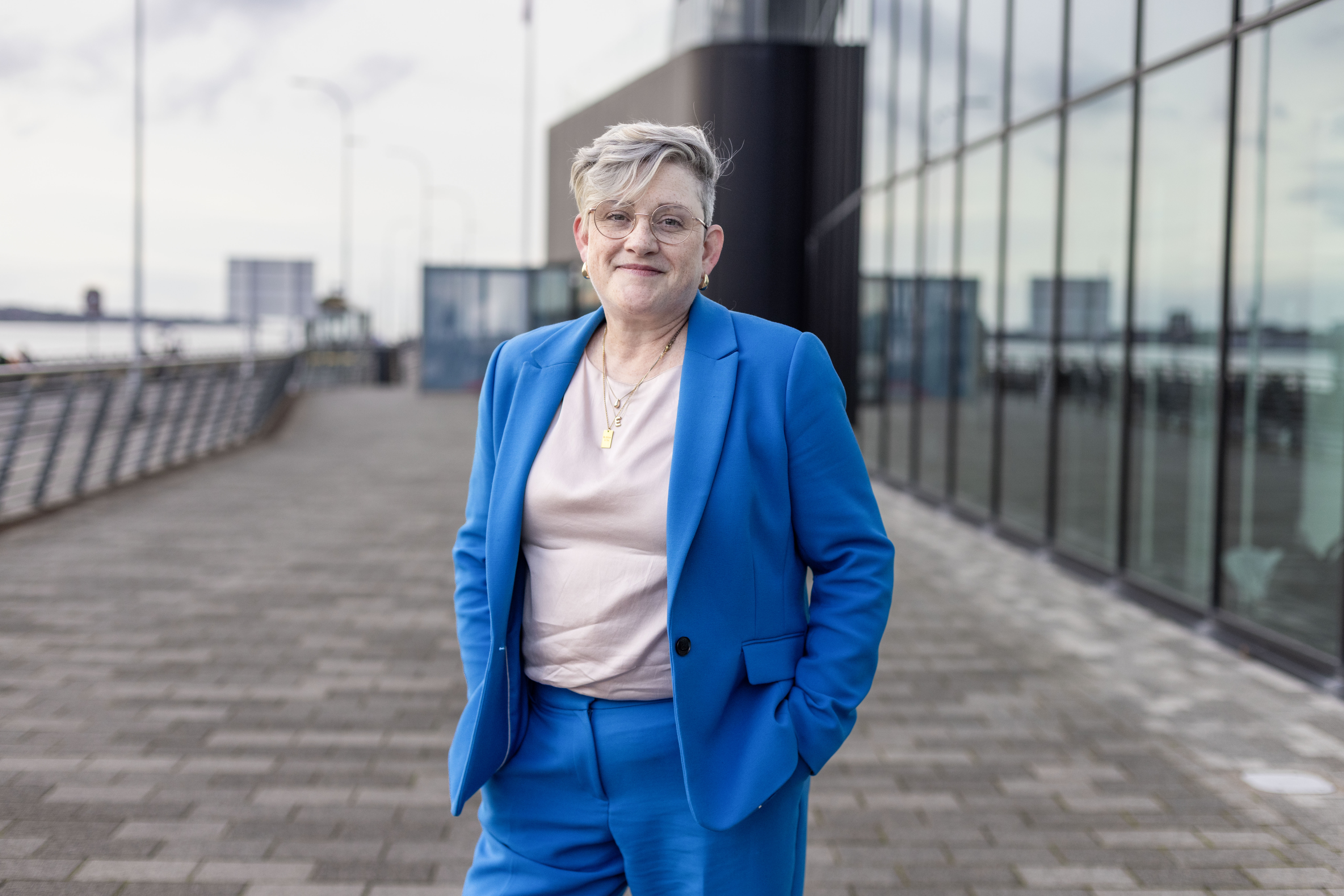 Labour health minister Ashley Dalton in a blue suit with hands in pockets.