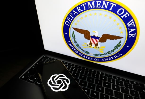 The OpenAI logo appears on a phone and the United States Department of War logo is displayed on a laptop