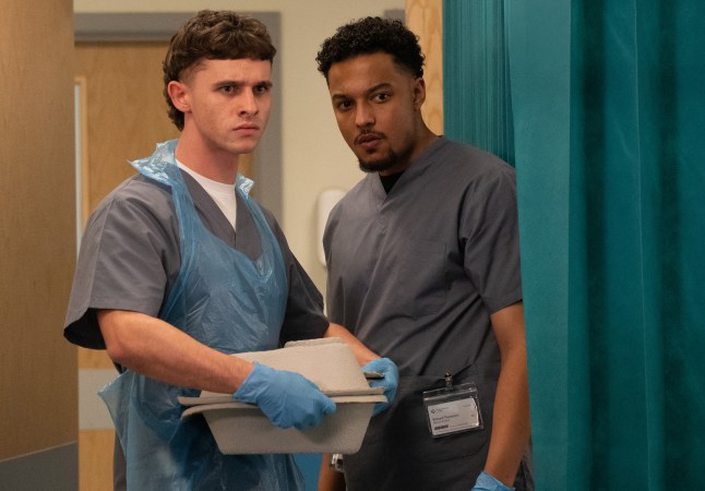 Jacob Gallagher standing with his colleague in the hospital, both looking extremely concerned, in Emmerdale.