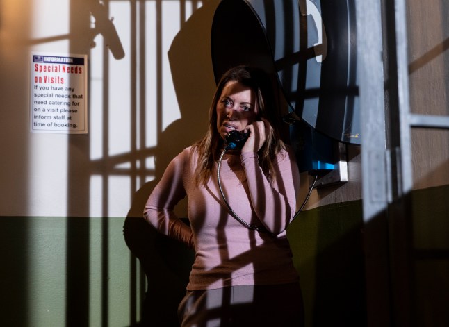 Lou on the phone in prison in Corrie