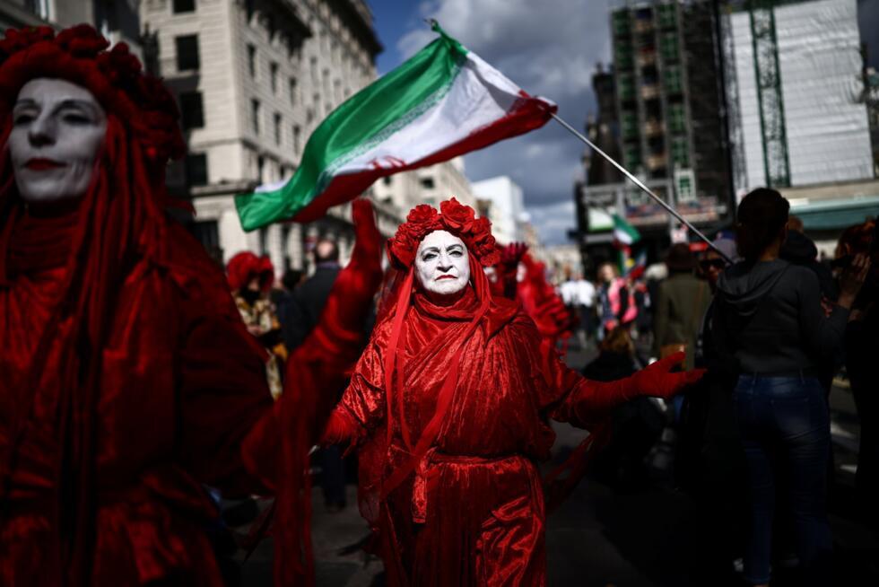 Members of the 'Red Rebel Brigade', a climate activist group, joined the march
