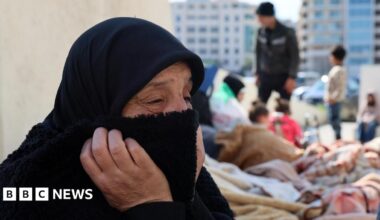 First responders walk past smoke rising from the site of an Israeli strike in Beirut's southern suburbs, Lebanon (3 March 2026)