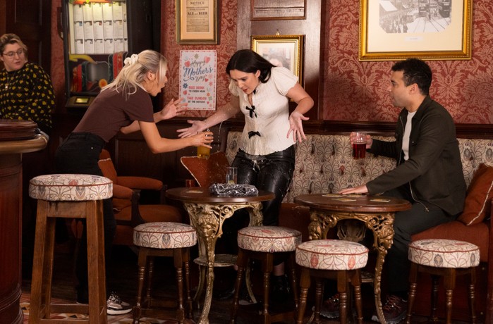 Amy stands in horror as Lauren pours a drink over her in a scene from Coronation Street