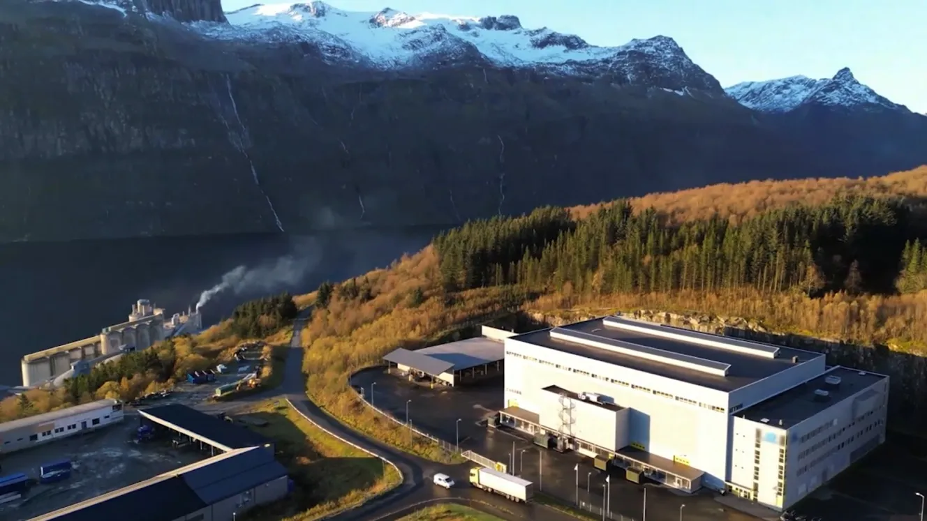 Nscale's world-class datacenter in Glomfjord, Norway, with mountains and forest in the background.