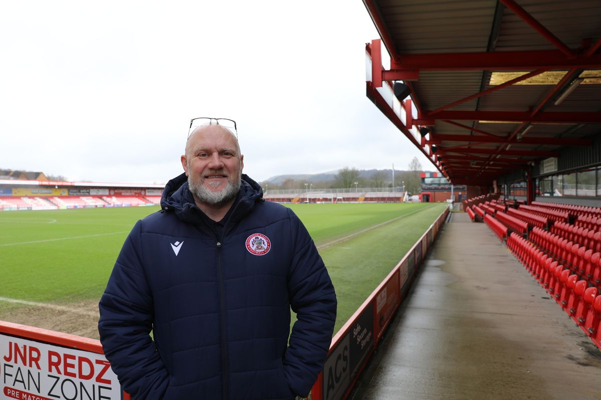 Wayne in front of the football pitch