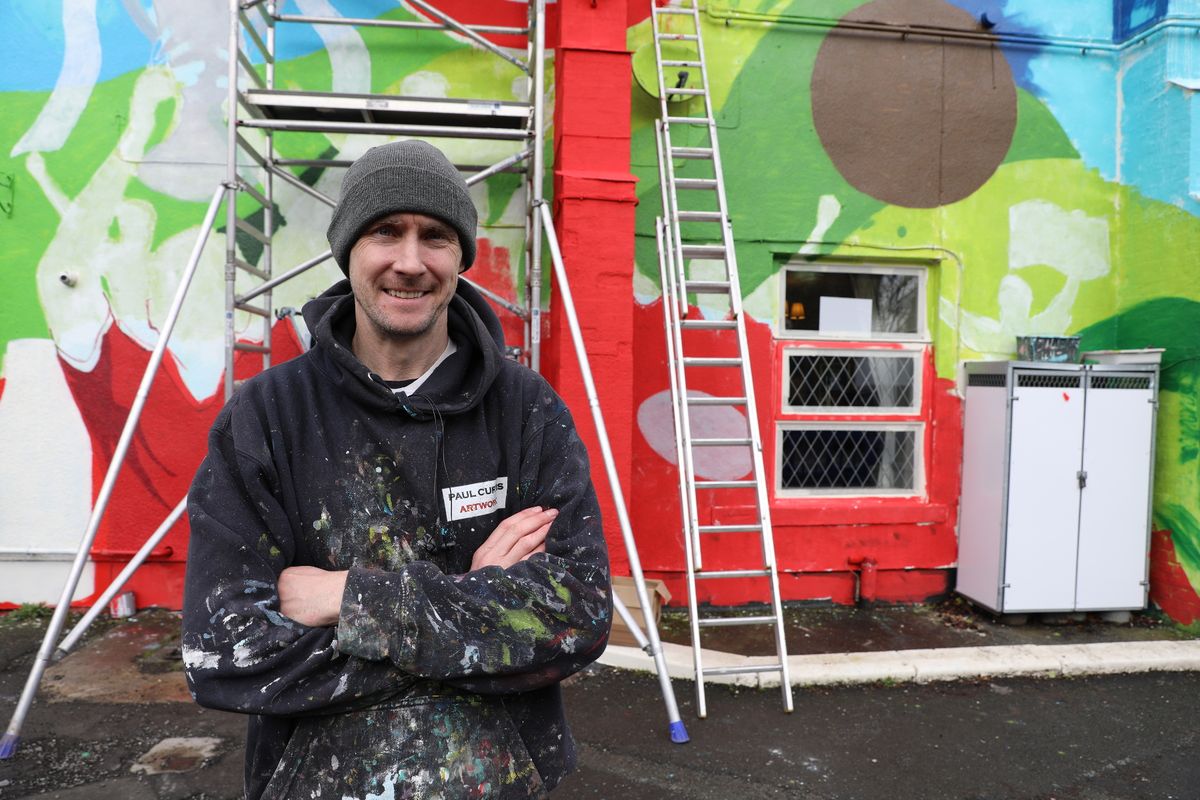 Paul in front of the mural