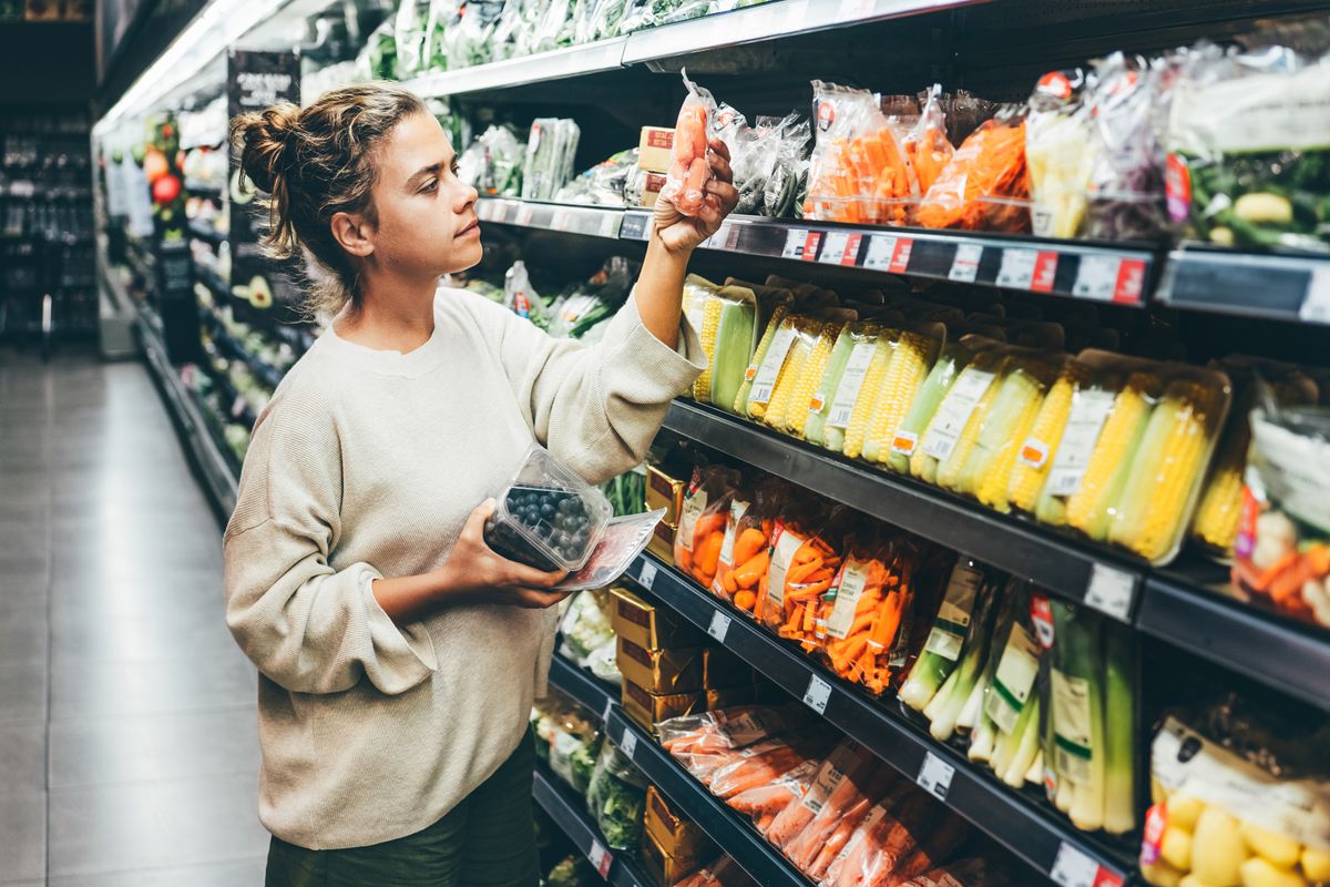 A woman is shopping in a supermarket.