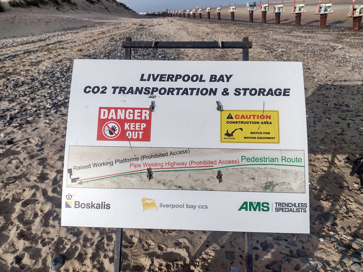 Warning 'Keep Out' sign advising walkers they must stay close to the dunes