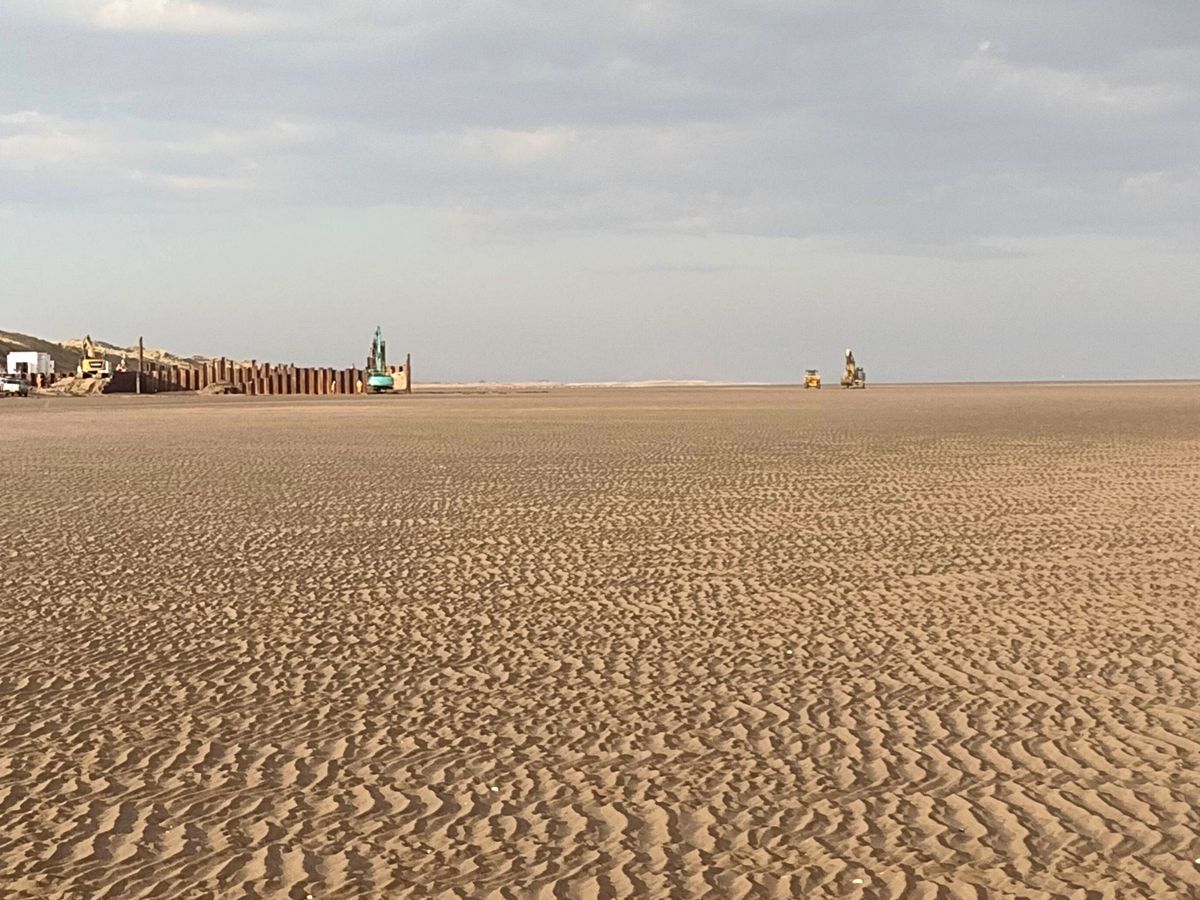 Construction of a cofferdam on the beach, through which a tunnel will be drilled under the dunes to accommodate the combined electric and fibre-optic conduit