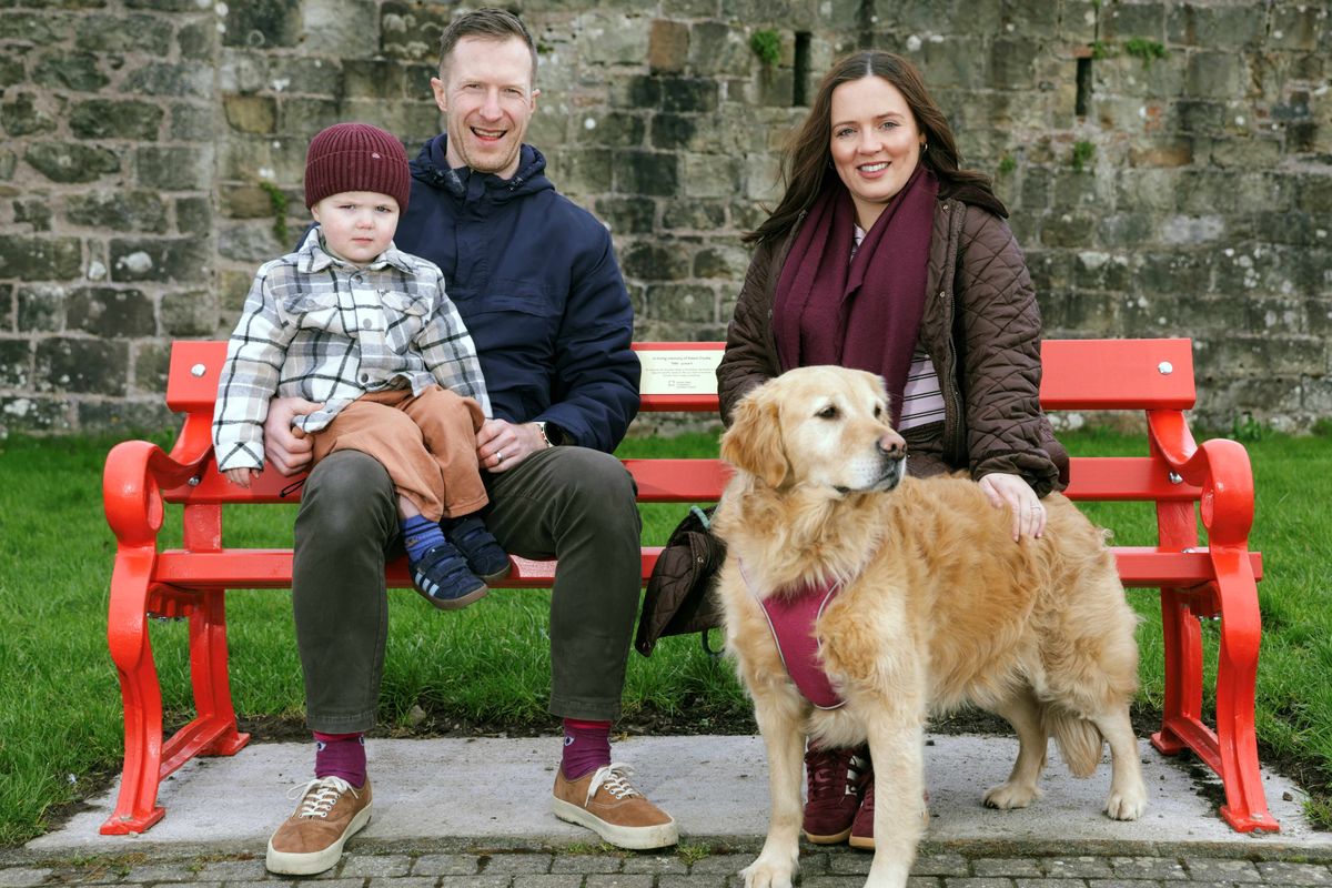 Adam Cooke  with wife Hannah, son Alfie and dog Polly at the British Heart Foundation bench installed in living tribute to Adam, having survived a cardiac arrest two years ago.