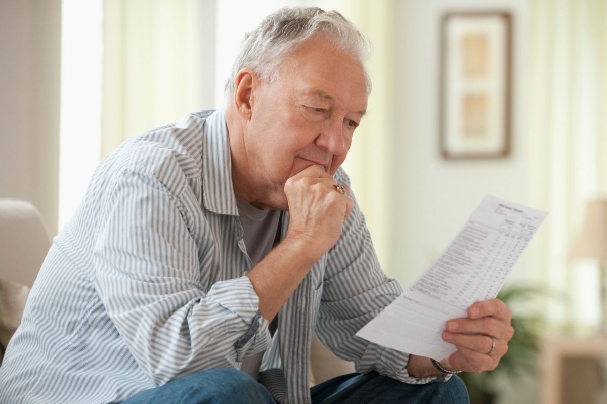 Man reading bills