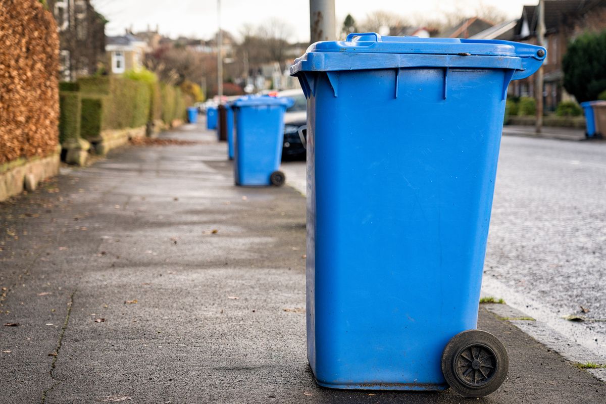 Recycling bins put on the pavement for collection outside houses in Glasgow, Scotland.