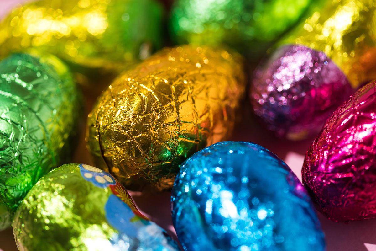 Colored chocolate easter eggs wrapped with green, yellow and blue foil