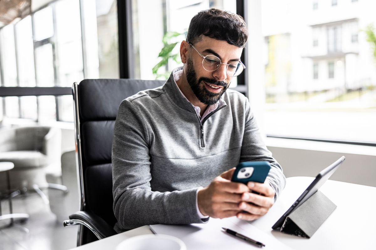 Businessman using smartphone in modern office