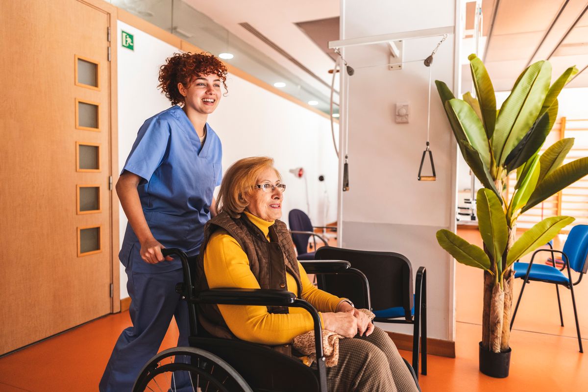 Woman pushing person in wheelchair