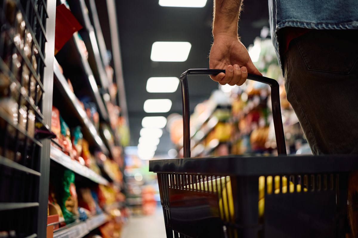 Close up of man buying groceries in supermarket