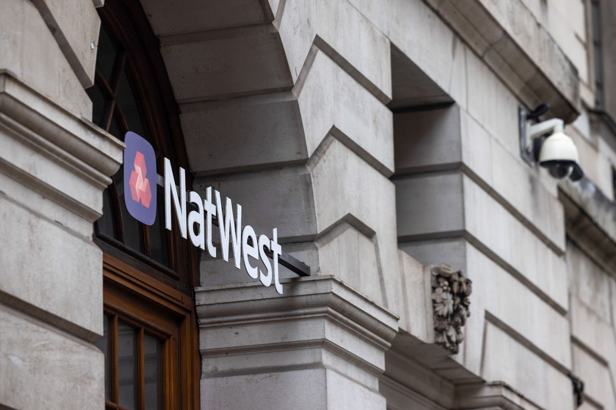 A sign above the entrance to a NatWest Group Plc bank branch in London, UK, on Friday, Feb. 6, 2026. NatWest Group Plc agreed to buy wealth manager Evelyn Partners, as the British bank looks to increase its access to affluent clients in its home market. Photographer: Chris Ratcliffe/Bloomberg via Getty Images