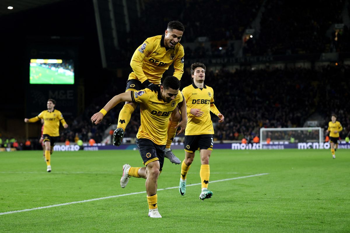 Wolverhampton Wanderers' Brazilian defender #07 Andre celebrates scoring the team's second goal with teammate Wolverhampton Wanderers' Brazilian midfielder #08 Joao Gomes (top) during the English Premier League football match between Wolverhampton Wanderers and Liverpool at the Molineux stadium in Wolverhampton, central England on March 3, 2026. (Photo by Darren Staples / AFP via Getty Images) / RESTRICTED TO EDITORIAL USE. No use with unauthorized audio, video, data, fixture lists, club/league logos or 'live' services. Online in-match use limited to 120 images. An additional 40 images may be used in extra time. No video emulation. Social media in-match use limited to 120 images. An additional 40 images may be used in extra time. No use in betting publications, games or single club/league/player publications. 