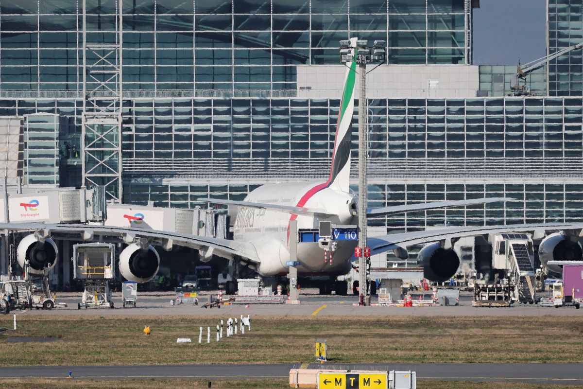 An Emirates passenger plane docks at the terminal at Frankfurt Airport from Dubai 