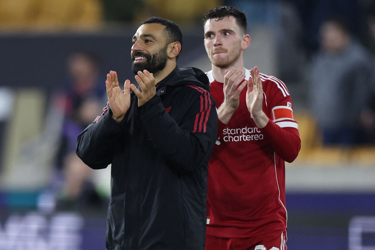 Liverpool's Egyptian striker #11 Mohamed Salah (L) and Liverpool's Scottish defender #26 Andrew Robertson (R) applaud fans on the pitch after the English FA Cup fifth round football match between Wolverhampton Wanderers and Liverpool at the Molineux stadium in Wolverhampton, central England on March 6, 2026. Liverpool won the game 3-1. (Photo by Darren Staples / AFP via Getty Images) / RESTRICTED TO EDITORIAL USE. No use with unauthorized audio, video, data, fixture lists, club/league logos or 'live' services. Online in-match use limited to 120 images. An additional 40 images may be used in extra time. No video emulation. Social media in-match use limited to 120 images. An additional 40 images may be used in extra time. No use in betting publications, games or single club/league/player publications. /