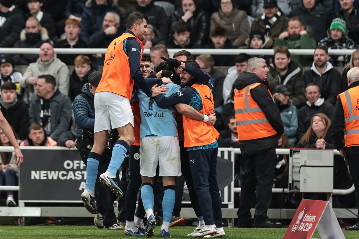 Manchester City's players celebrate as they advance to the quarter finals of the FA Cup