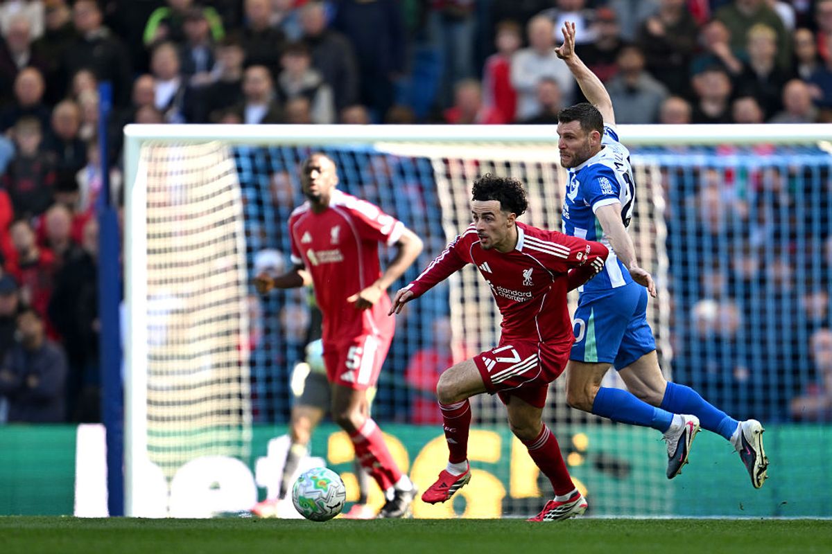 Curtis Jones of Liverpool is challenged by James Milner of Brighton & Hove Albion