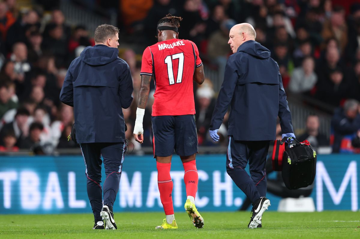 Noni Madueke of England leaves the game injured during the international friendly match between England and Uruguay at Wembley Stadium
