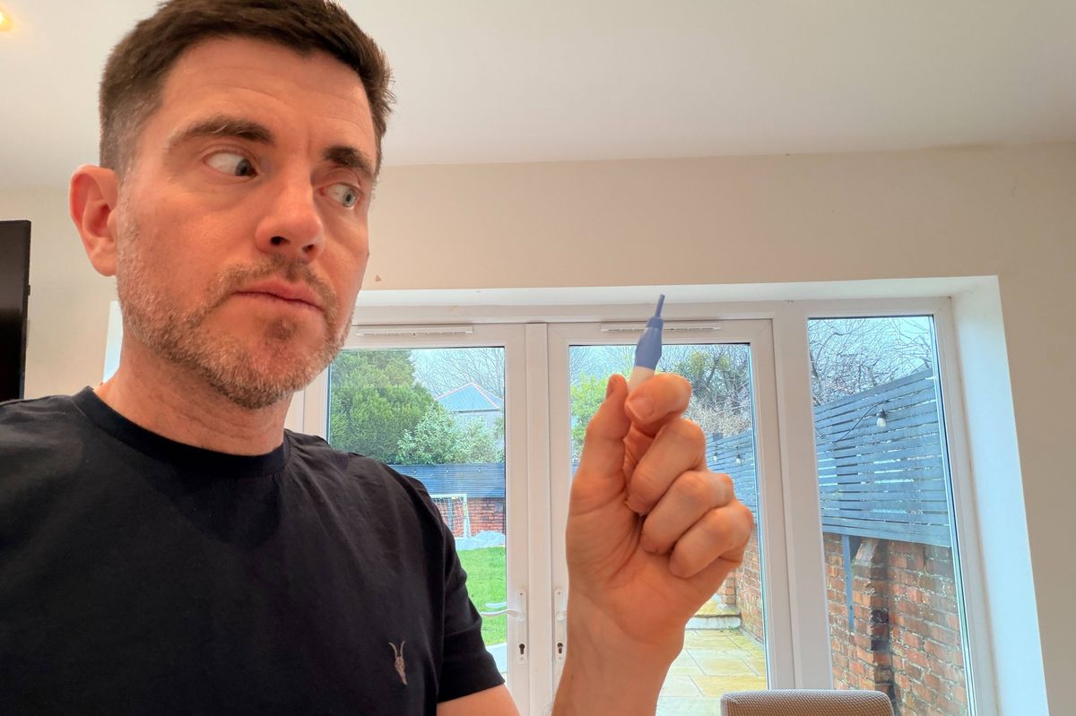 Steffan Rhys looks nervously at a lance he is about to use to take a blood test at home