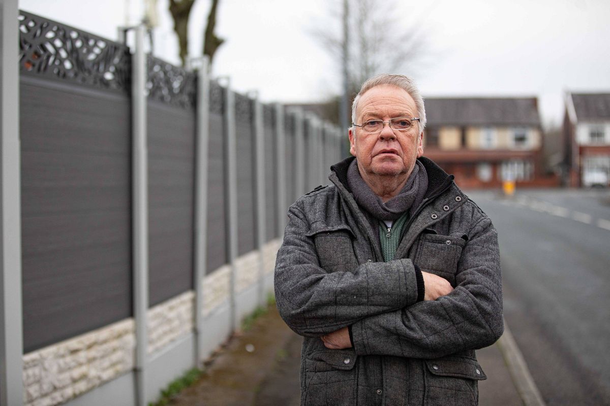 An elderly couple have blasted council bosses after being ordered to rip down a 6 ft tall fence built to stop people nosing into their house. David Hopwood, and his wife Denise, erected the grey composite fence in front of their Home in Farnworth, Bolton, Gtr Manchester, to provide privacy and security. March 9, 2026. // A retired couple have hit out at council chiefs who have ordered them them to rip down a £4,500 seven foot high fence - because of its colour. David and Denise Hopwood erected the 25 metre long, grey composite fence around their home after ripping up an old, nine-foot-high hedge that they were finding difficult to maintain. However a neighbour complained about its height forcing David, 67, and Denise, 66, to see retrospective planning permission. This week the couple, from Bolton, Gtr Manchester, were told permission had been refused because it was' out of touch with the character and appearance of the surrounding area.' The couple hit back saying that the hedge had become 'too difficult to maintain' at their age and was costing £800 a year to look after.