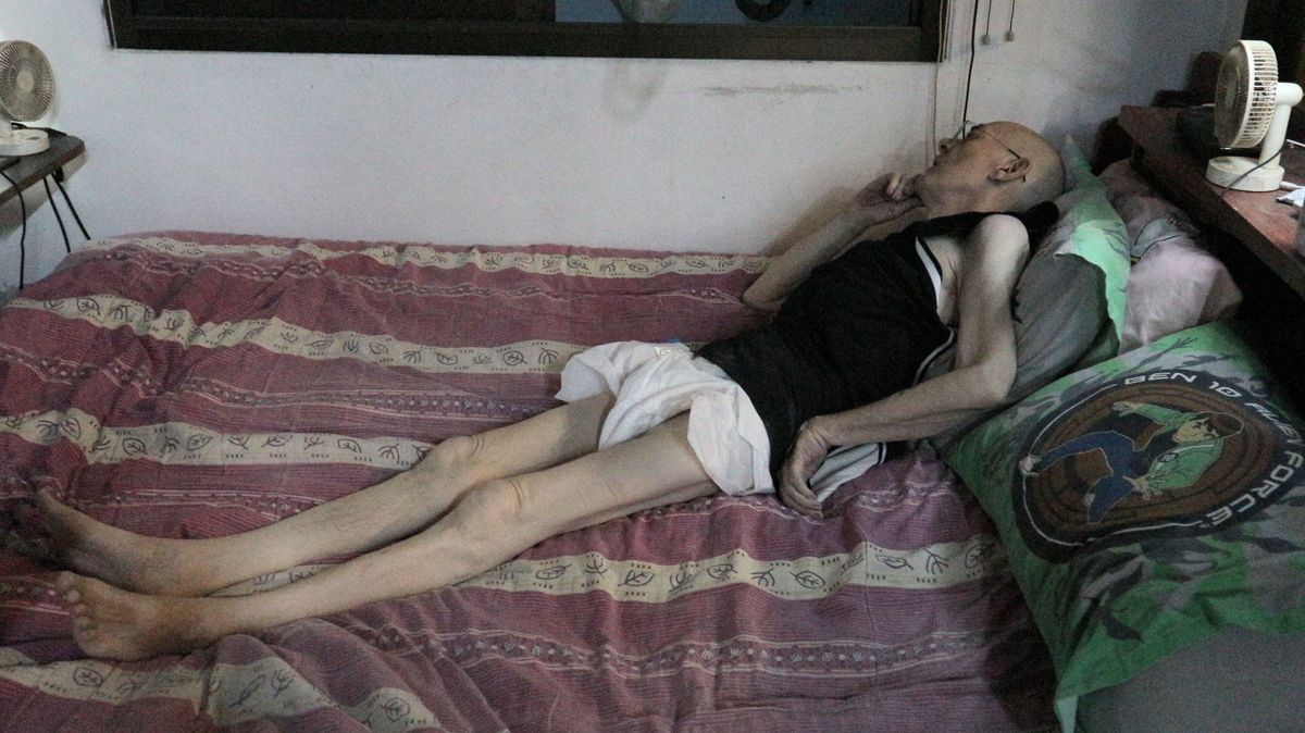 David Carey, 59, lying in bed on the phone