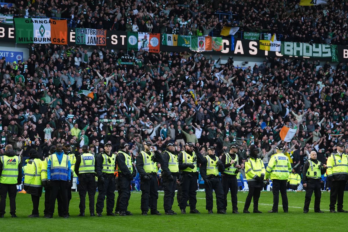 Police stand in front of fans as Celtic and Rangers fans invade the pitch at full time, following the Scottish Gas Men's Scottish Cup quarter-final match at Ibrox Stadium, Glasgow. Picture date: Sunday March 8, 2026.