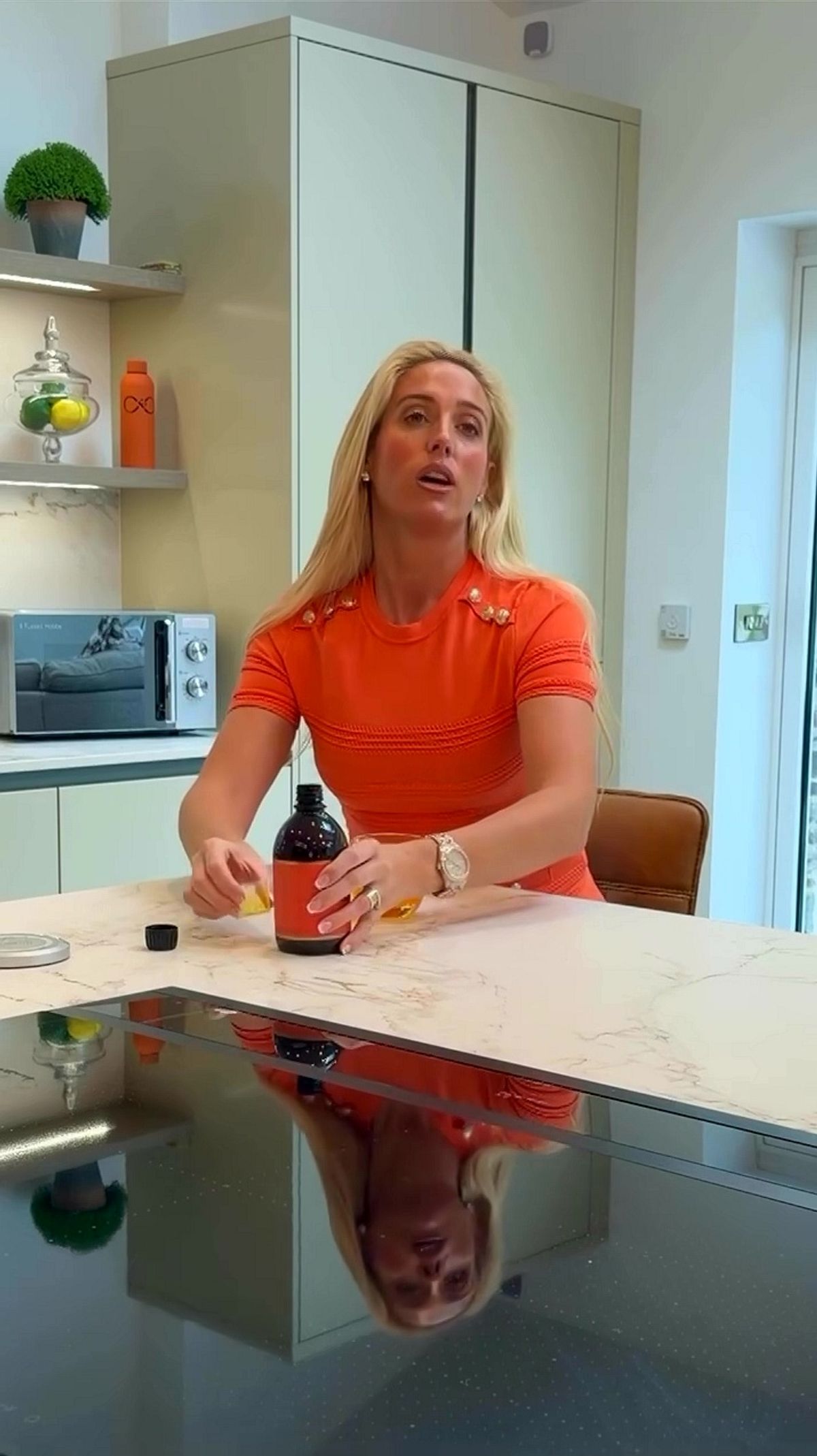 Paris Fury in an orange top