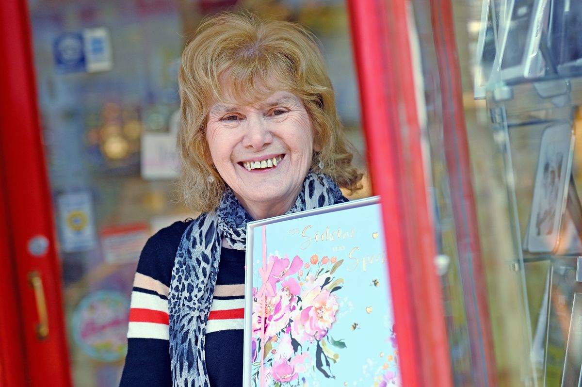 The image shows Margaret holding a card