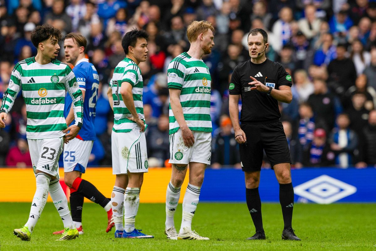 Referee Don Robertson speaks to VAR before ruling out the goal by Daizen Maeda for an offside by Liam Scales in the build up