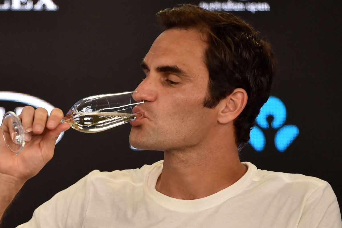 Roger Federer drinks champagne