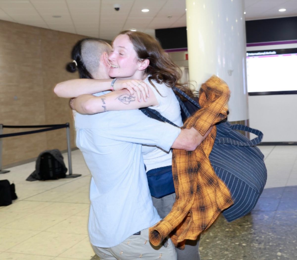 Loved ones hug each other on return to Scotland